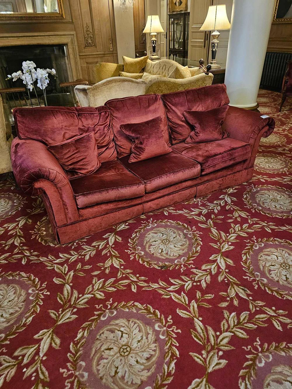 Lot 149: A Deep Red Velvet Three-Seater Sofa with Rolled Arms