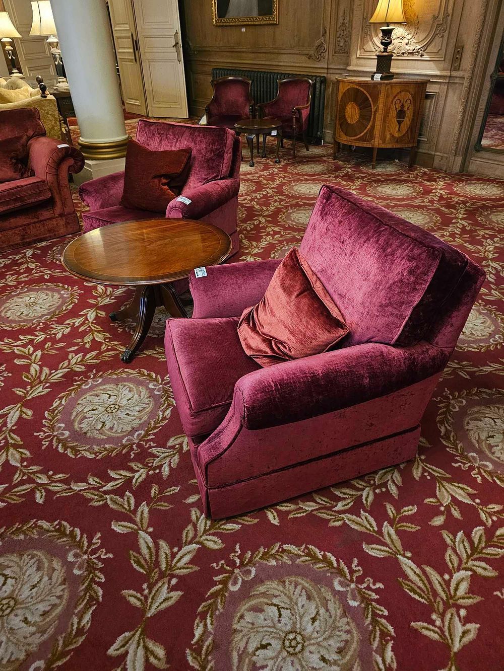 Lot 151: A Group of Three Red Velvet Armchairs and an Occasional Table