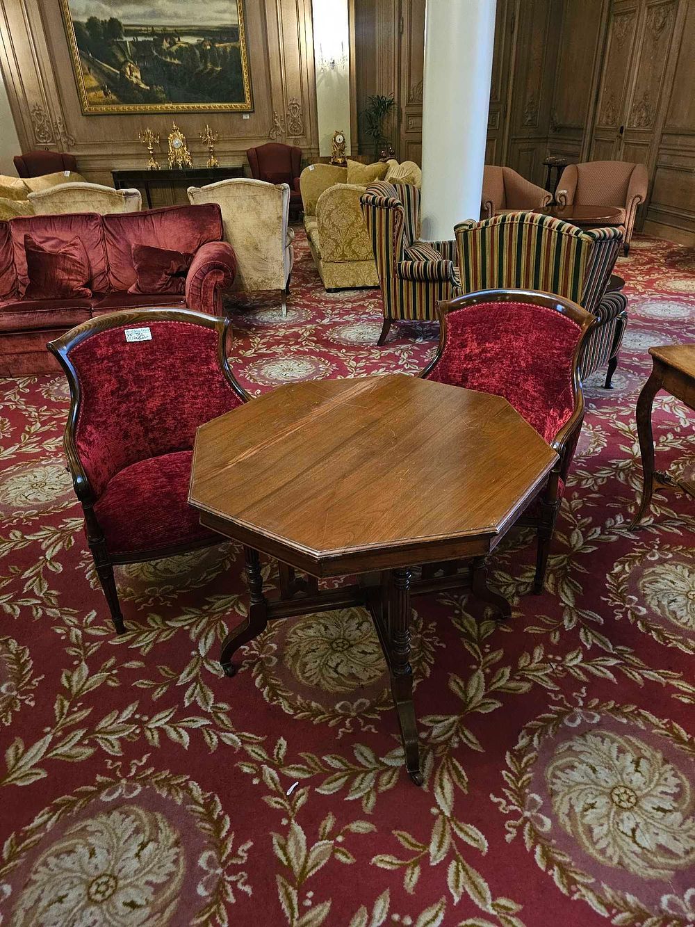 Lot 152: An Edwardian Style Walnut Octagonal Centre Table and a Pair of Red Velvet Upholstered Armchairs