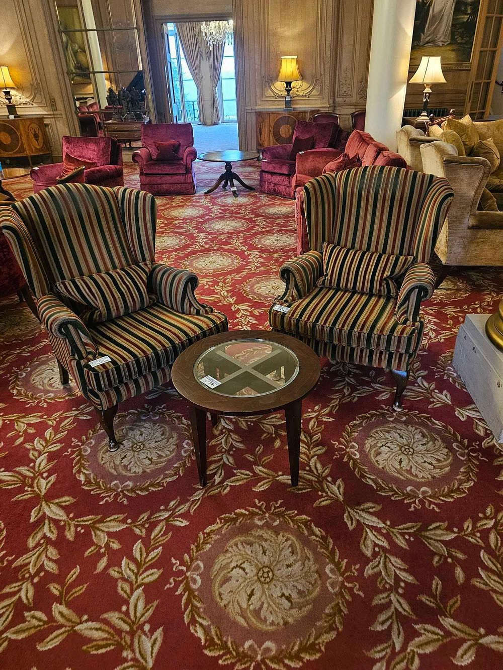 Lot 154: A Pair of Mid-20th Century Style Wingback Armchairs and a Circular Side Table