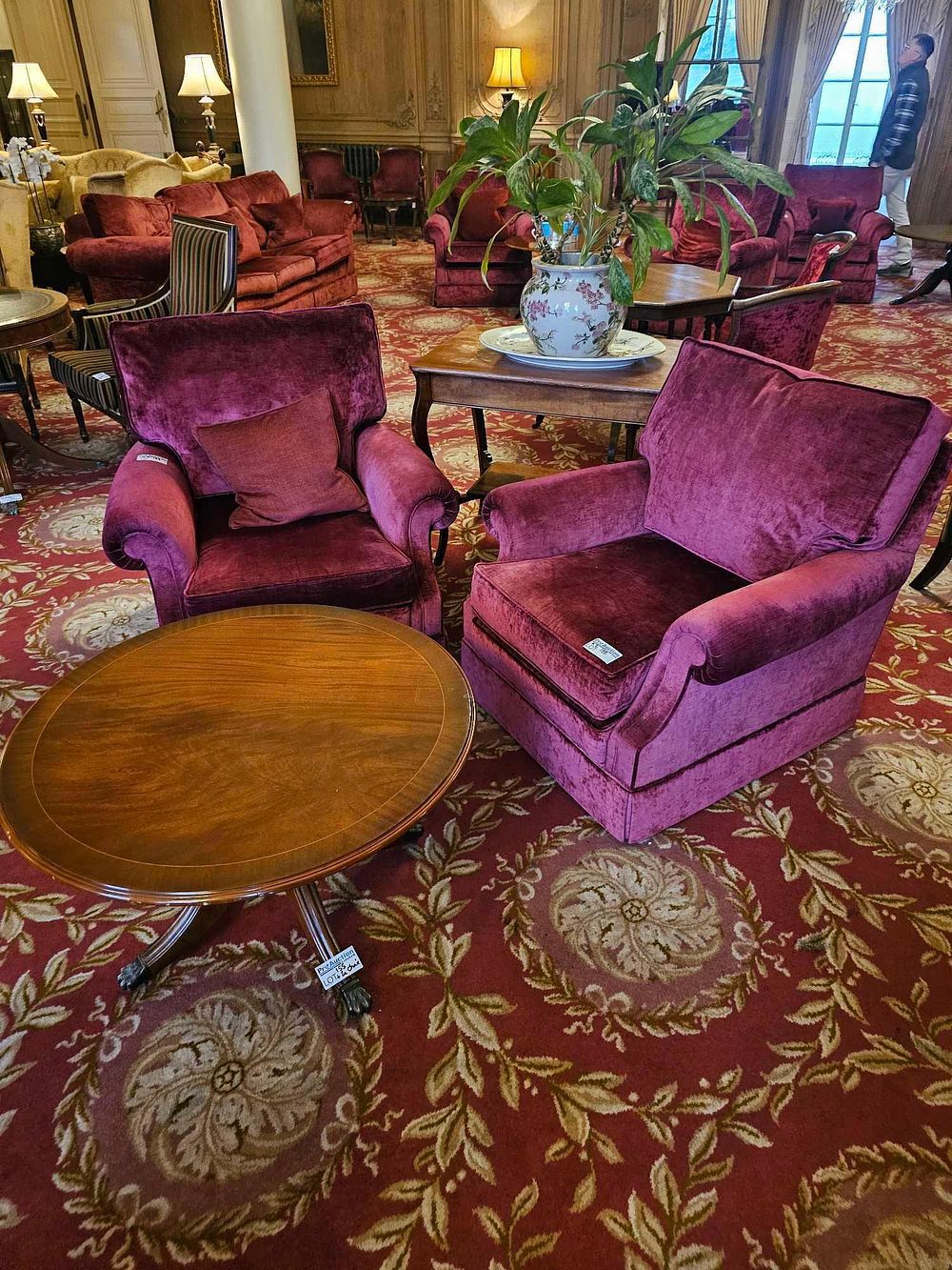 Lot 155: A Pair of Traditional Red Velvet Club Chairs and a Pedestal Side Table