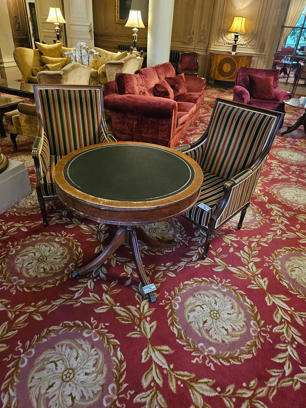 Lot 156: A Three-Piece Regency Style Mahogany Drum Table and Pair of Armchairs