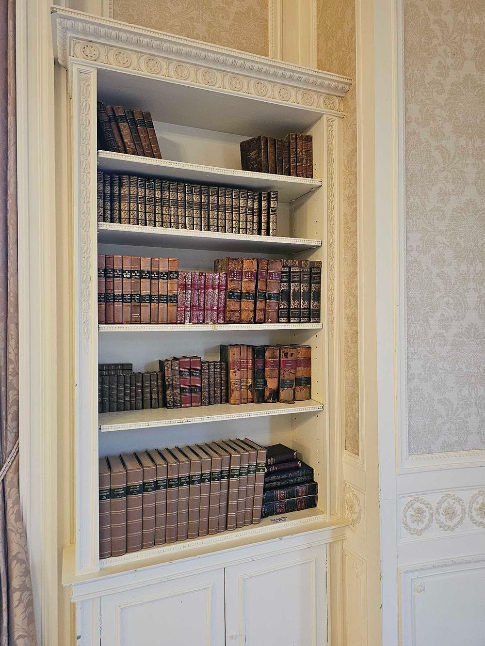 Lot 176: A Late 19th/Early 20th Century Style Painted Built-in Bookshelf with a Library of Historical and Legal Volumes