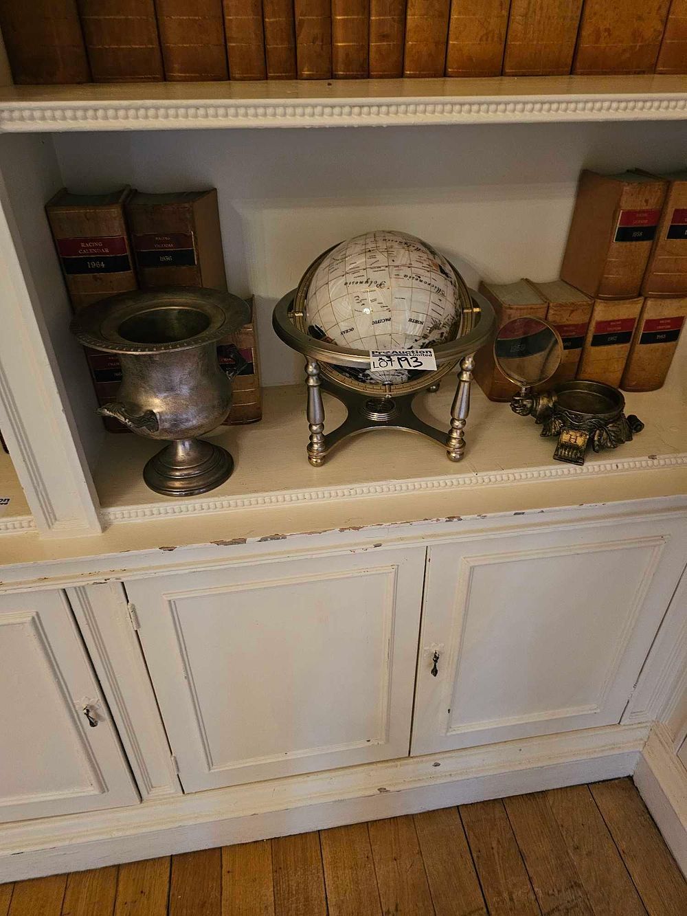 Lot 193: A Unique Art Pearl White Ocean Desktop Gemstone Globe, with a Silver-Toned Urn and a Magnifying Glass on Stand