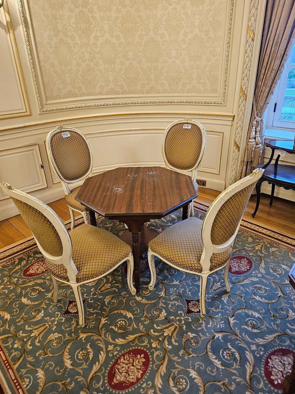 Lot 196: An Octagonal Mahogany Pedestal Table and Four Louis XVI-Style Painted Side Chairs