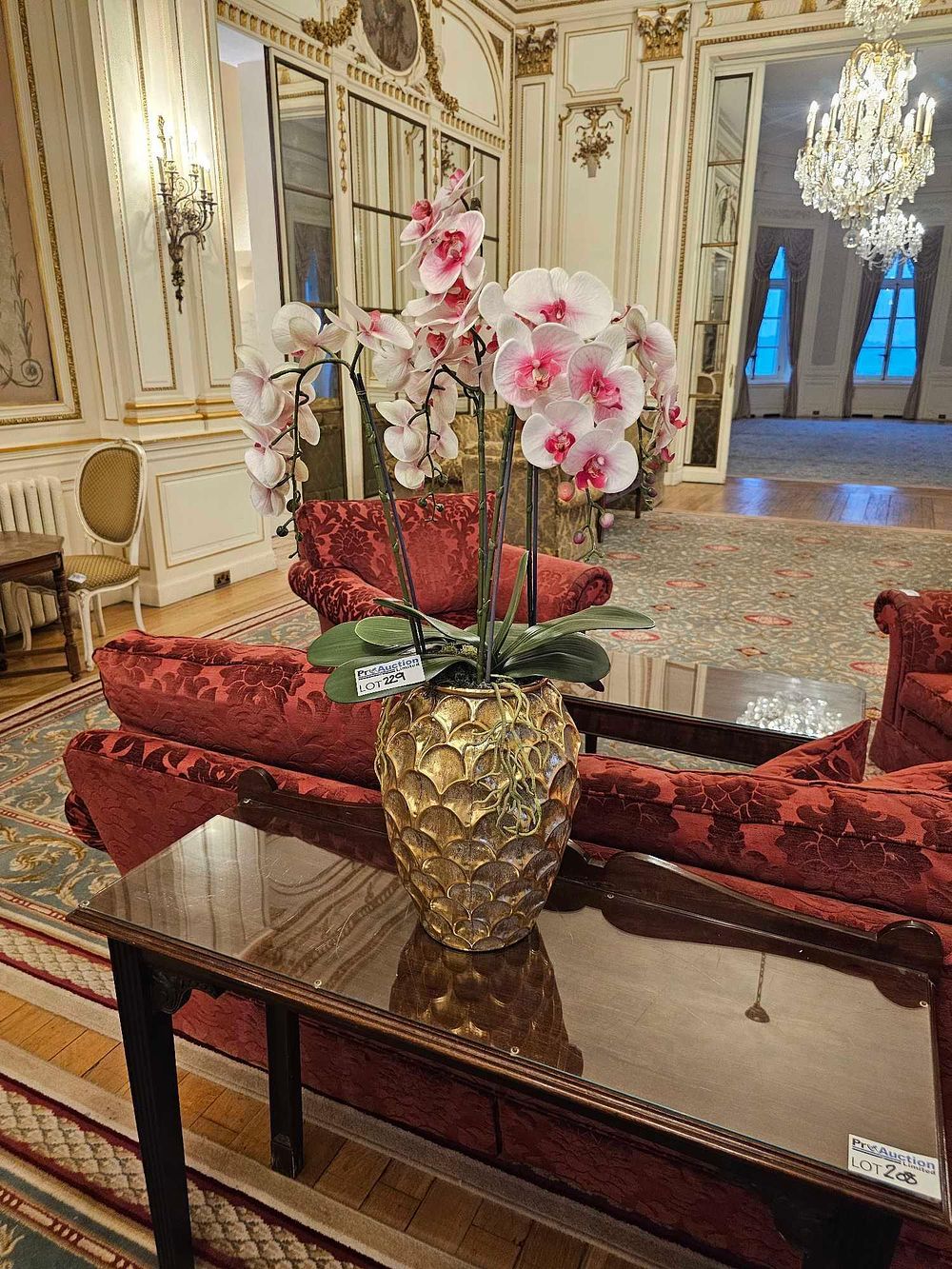 Lot 229: A Large Artificial Phalaenopsis Orchid in a Gilt-Finished Textured Planter