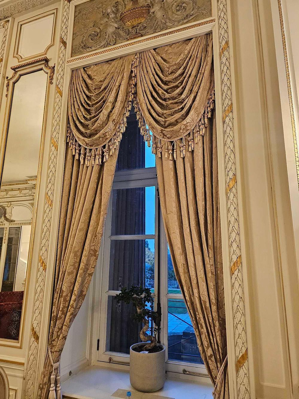Lot 238: A Pair of Gilt-Toned Damask Window Draperies with Swag Valance and Tassels