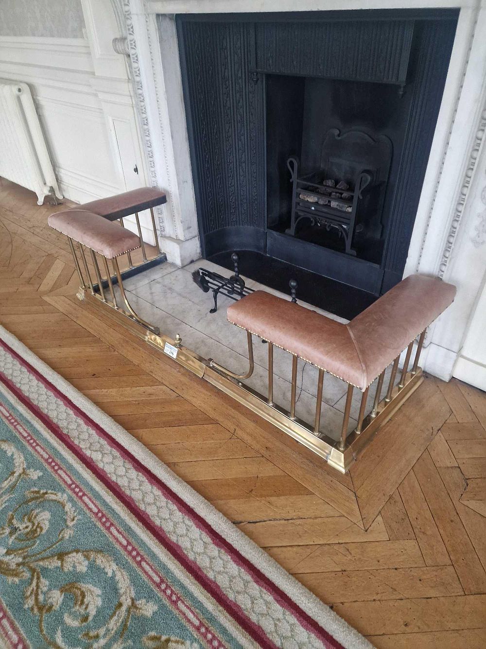 Lot 246: A Victorian/Edwardian Brass Club Fender and a Set of Wrought Iron Fireplace Tools