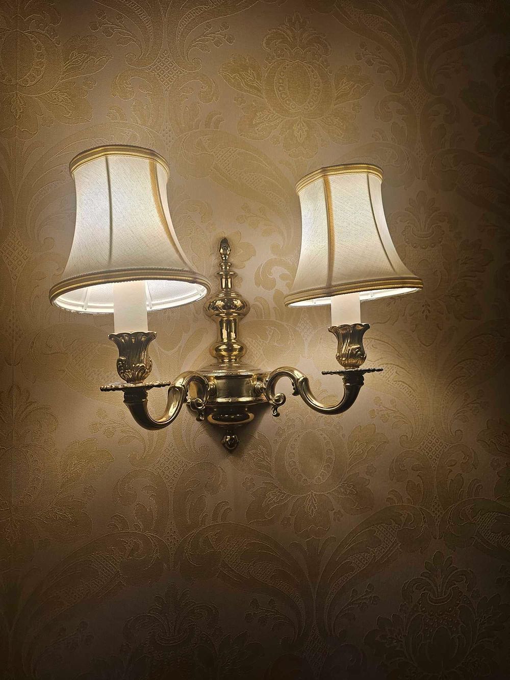 Lot 282: A Vintage Brass Dual-Arm Wall Sconce with Fabric Shades