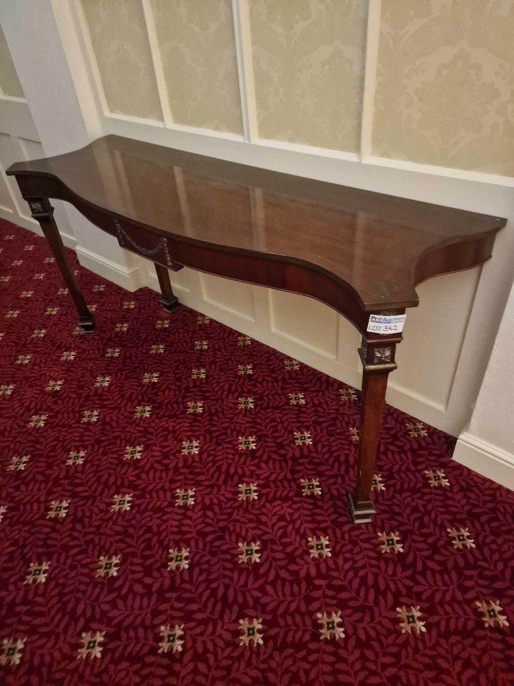 Lot 362: A Neoclassical Style Gilt-Metal Mounted Serpentine-Front Mahogany Console Table