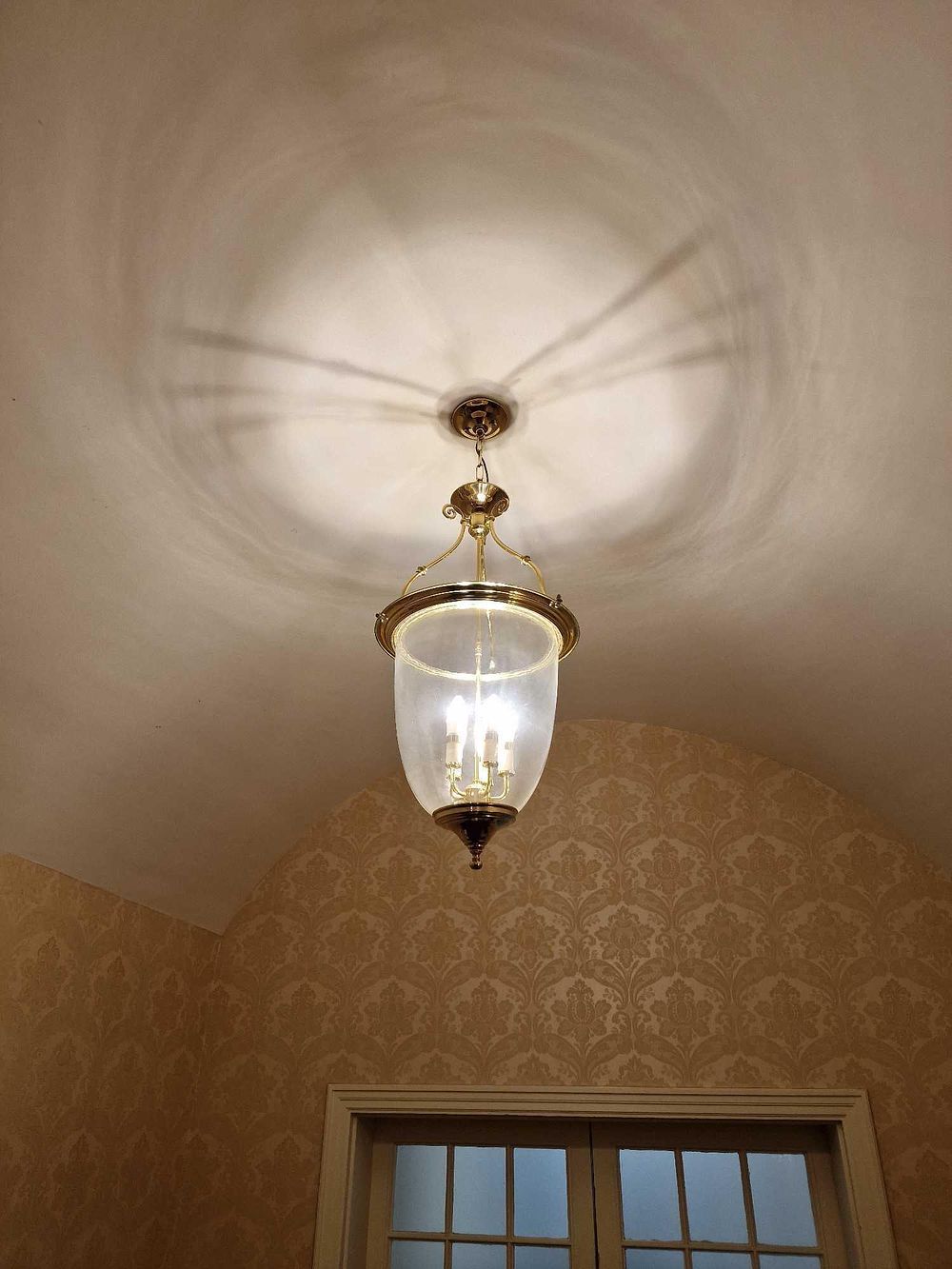 Lot 366: A Revival Style Polished Brass and Glass Three-Light Lantern-Style Pendant Light