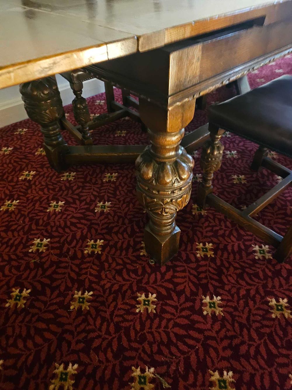 Lot 394: An Early 20th Century Jacobean Revival Oak Dining Table and Set of Six Chairs