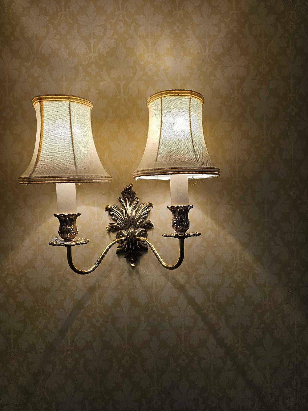 Lot 530: A Pair of Rococo Revival Style Brass Double-Arm Wall Sconces