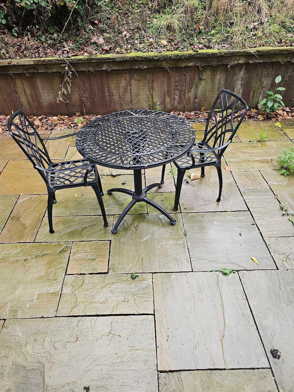 Lot 588: A Three-Piece Black-Painted Cast Aluminum Openwork Garden Bistro Set