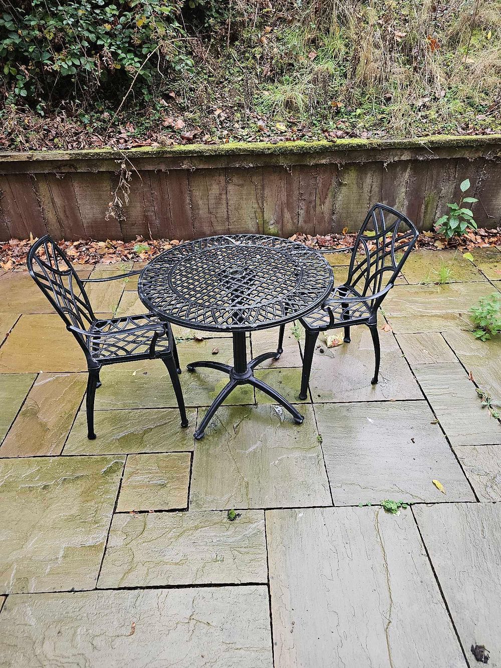 Lot 589: A Three-Piece Black Cast Aluminum Outdoor Bistro Set