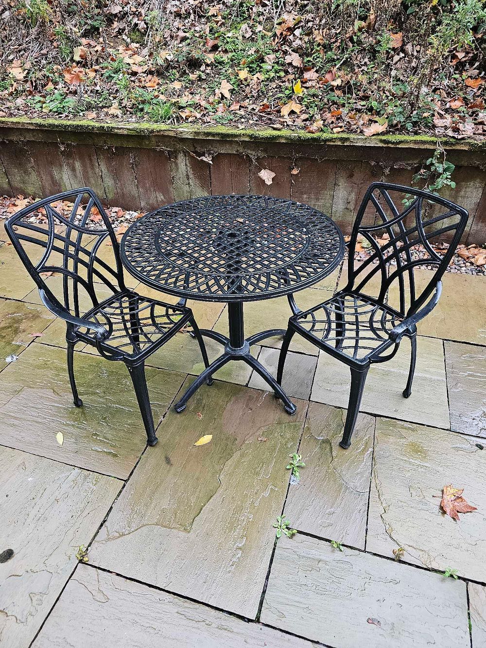 Lot 596: A Three-Piece Black Cast Aluminum Outdoor Bistro Set