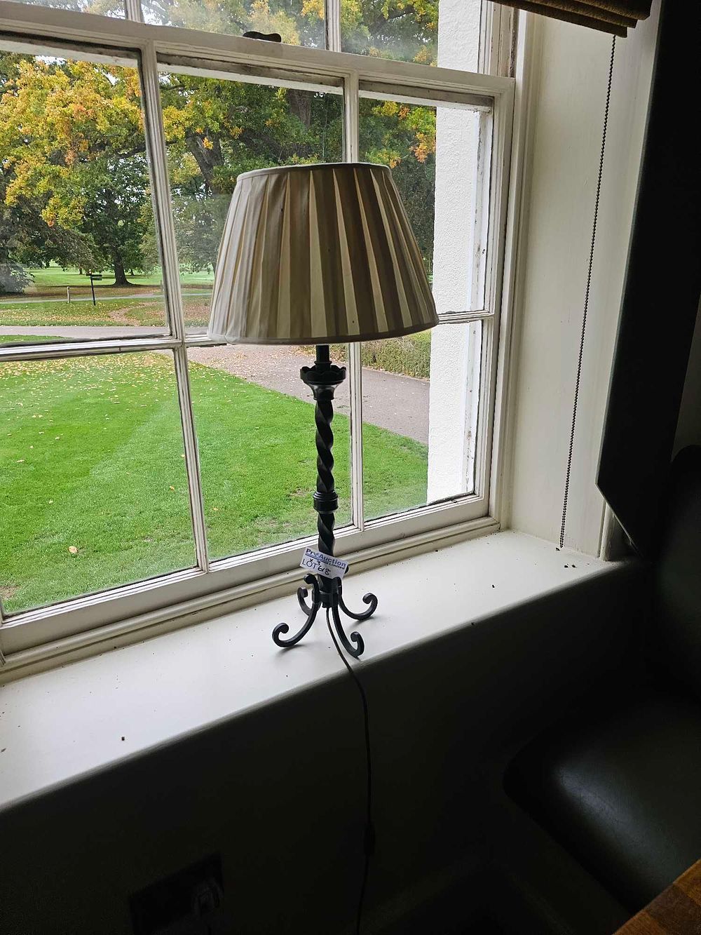 Lot 618: A Wrought Iron Barley Twist Table Lamp with Pleated Fabric Shade