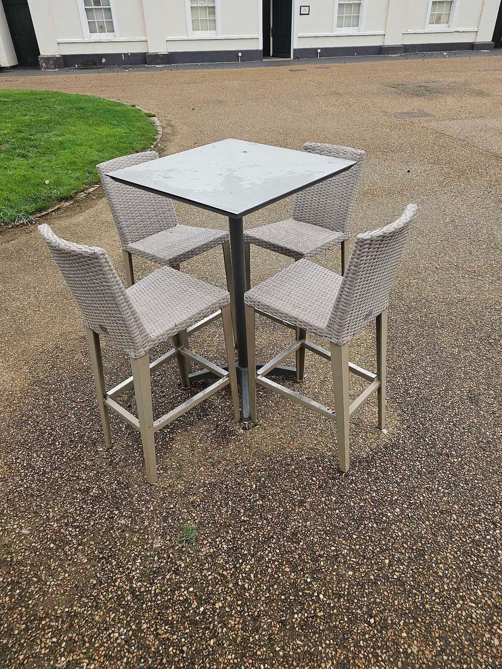 Lot 641: A Contemporary Five-Piece Outdoor Bar Height Dining Set