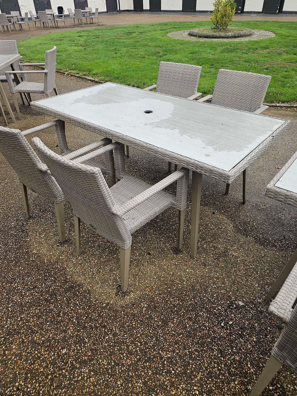 Lot 643: A Set of Seven Contemporary Outdoor Rattan-Style Dining Furniture
