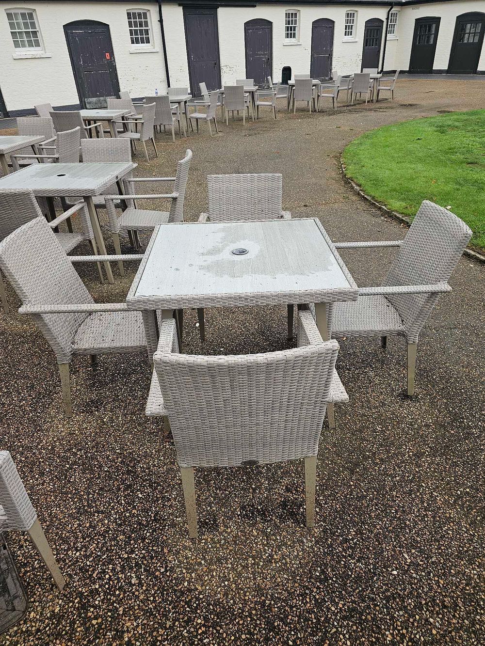 Lot 646: A Contemporary Five-Piece Outdoor Wicker-Style Dining Set