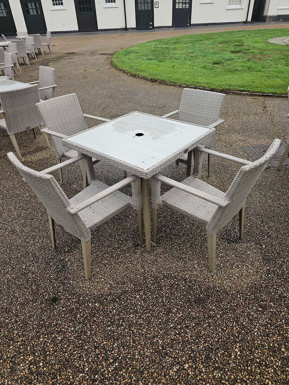 Lot 648: A Contemporary Five-Piece Outdoor Dining Set, Woven Synthetic Rattan and Glass