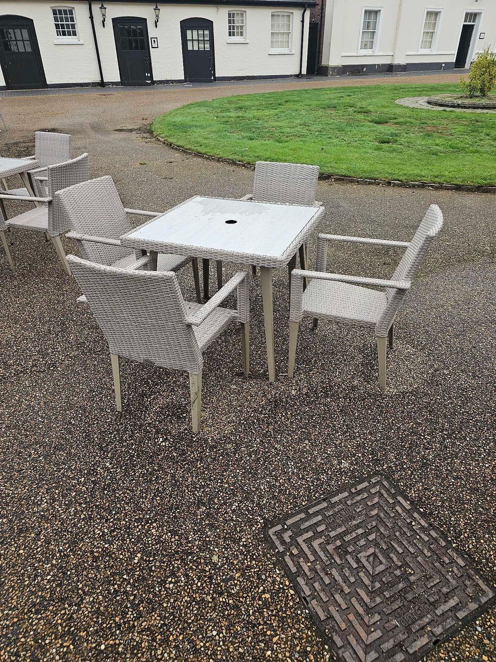 Lot 649: A Five-Piece Outdoor Rattan and Metal Dining Set, comprising a Square Glass-Top Table and Four Armchairs.