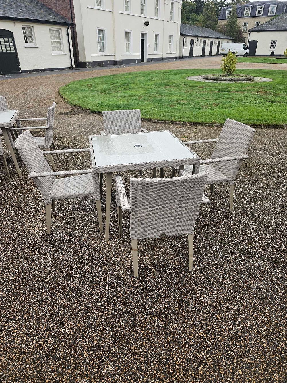 Lot 651: A Set of Five Outdoor Polyrattan Dining Furniture, comprising a Square Table and Four Armchairs