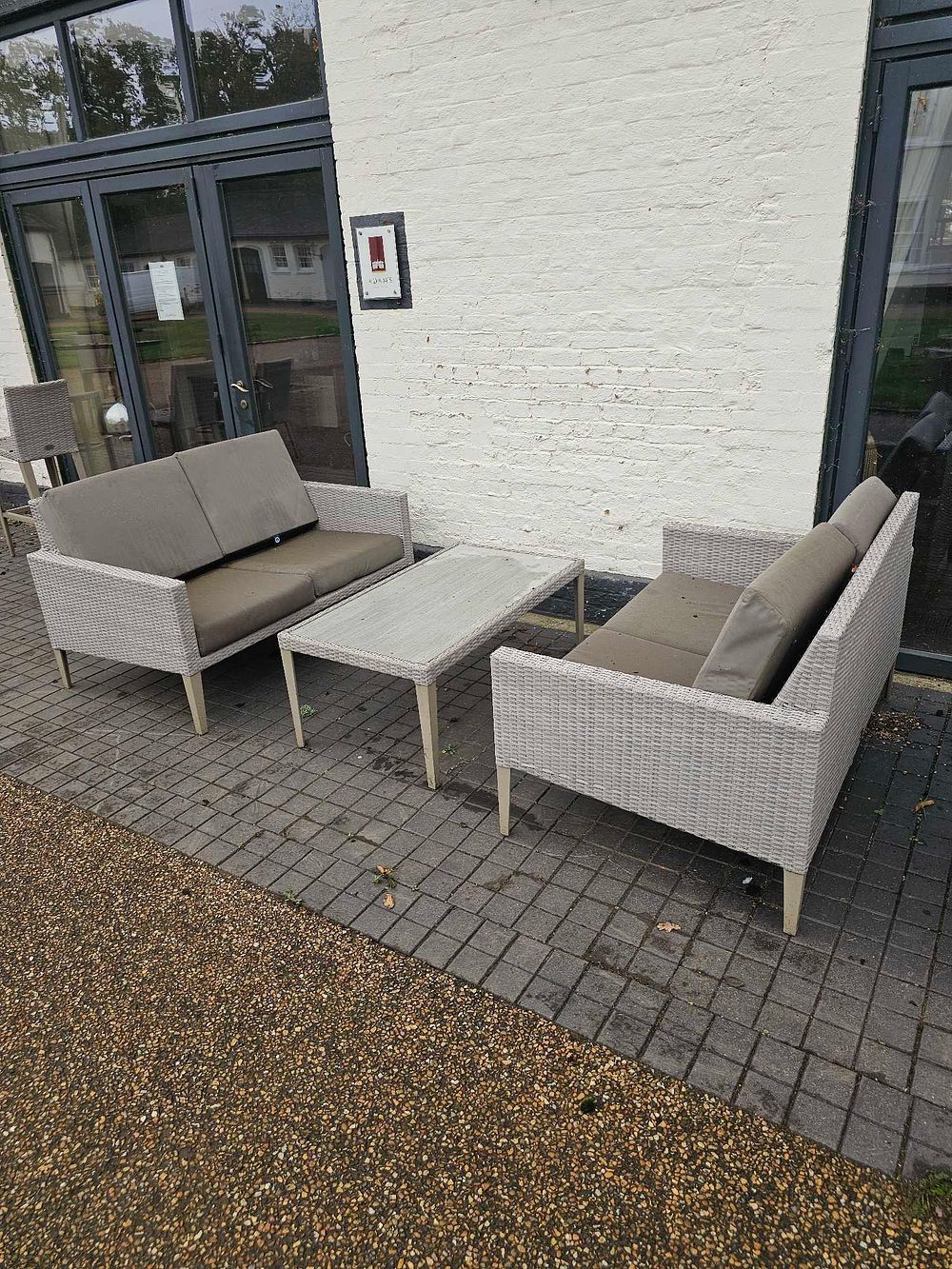 Lot 655: A Three-Piece Modern Outdoor Patio Set, comprising Two Two-Seater Sofas and a Coffee Table