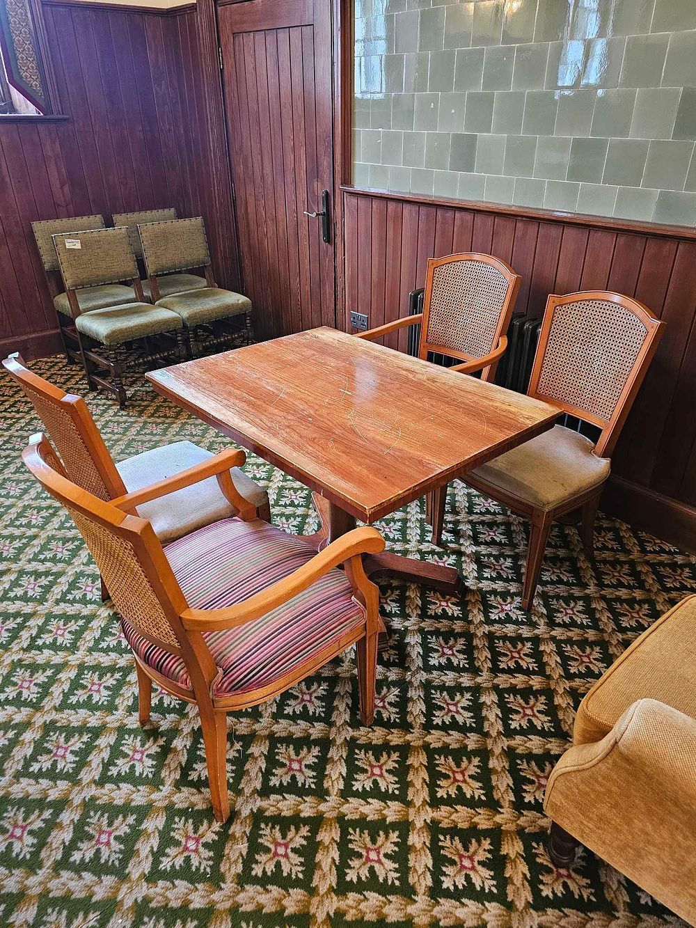 Lot 660: A Drexel Heritage Campaign Style Pedestal Dining Table with Three Drexel Passage Cane Back Chairs