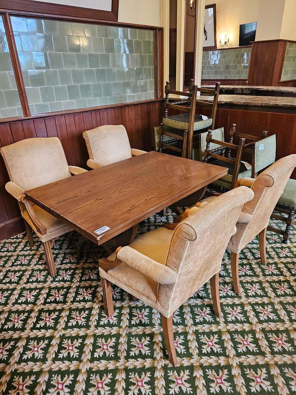 Lot 663: A Mid-20th Century Oak Dining Suite, comprising a Refectory Table and a Set of Six Upholstered Armchairs