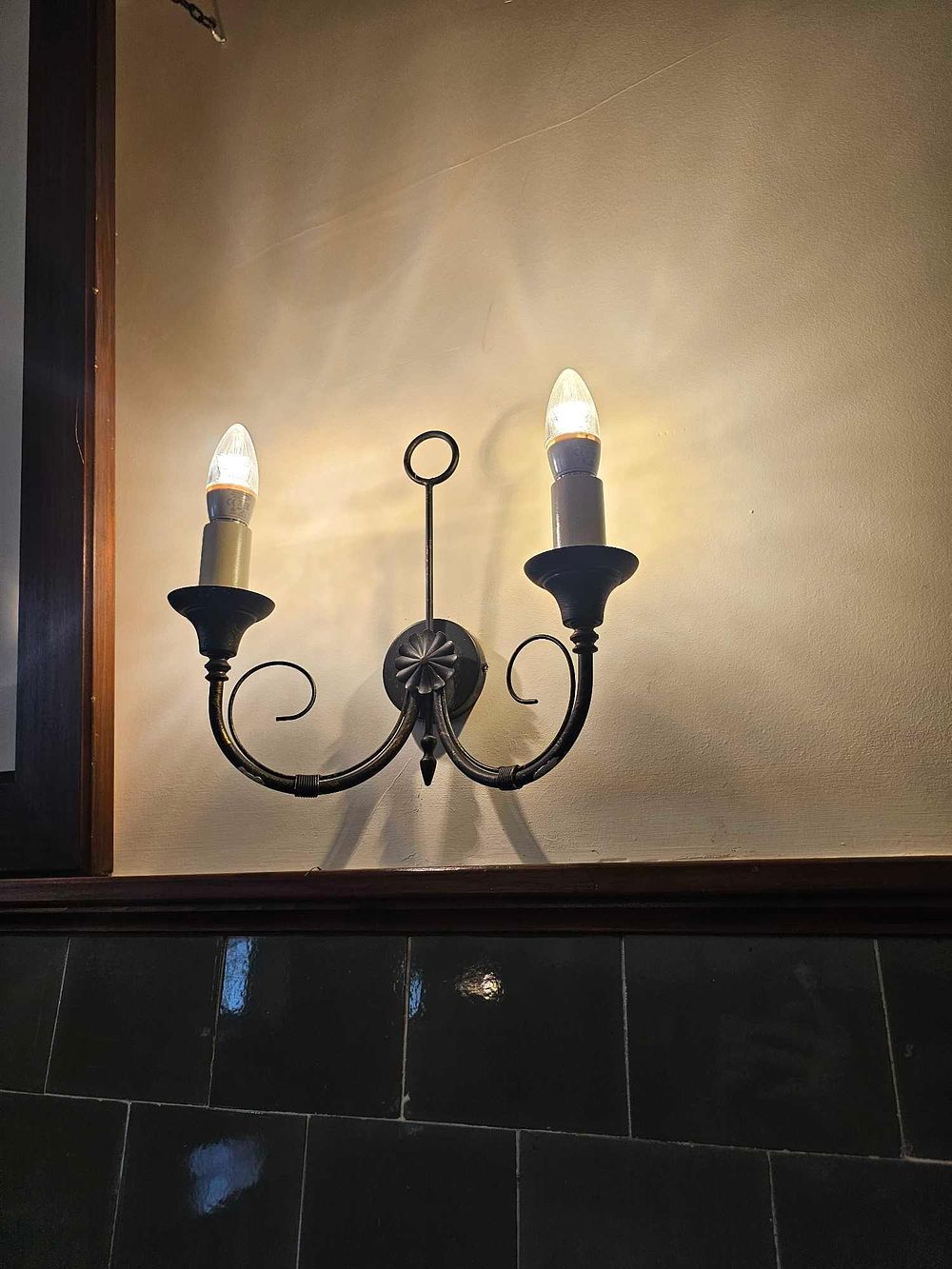 Lot 674: A Two-Light Candelabra-Style Wrought Iron Wall Sconce