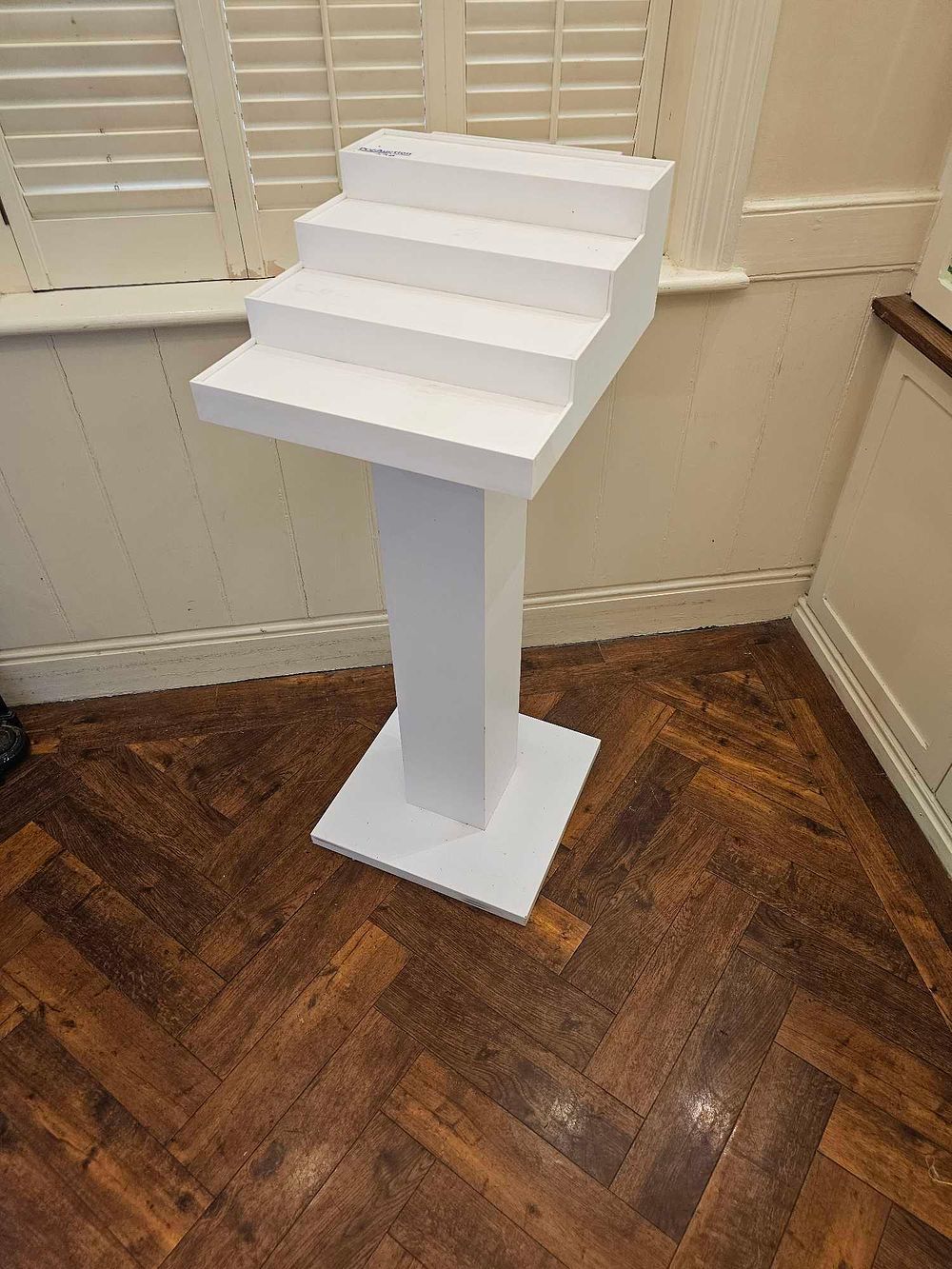 Lot 738: A Contemporary White Painted Stepped Display Pedestal, marked 'LivingSpaces'