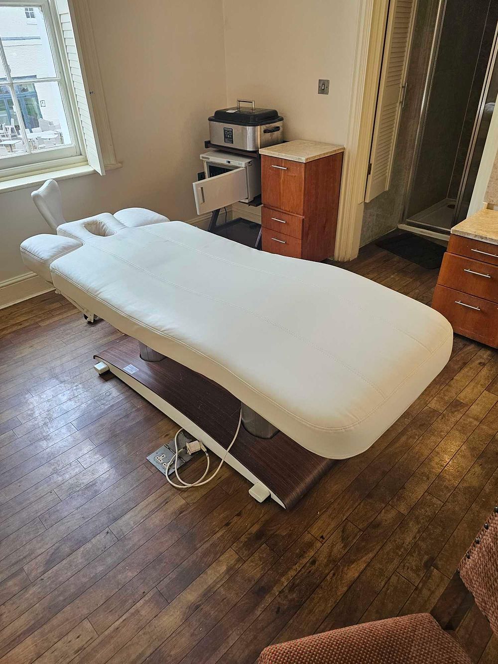 Lot 754: A Contemporary Electric Treatment Table and Aesthetician's Stool