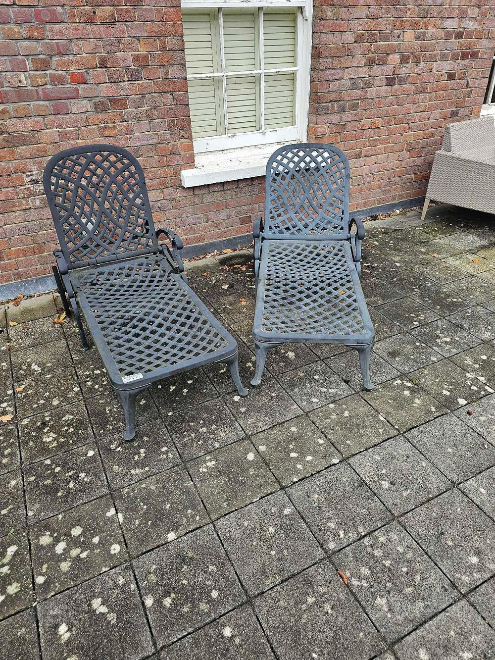 Lot 774: A Pair of Dark Grey Painted Cast Aluminum Outdoor Chaise Lounges, in the Tuscan Mediterranean Taste
