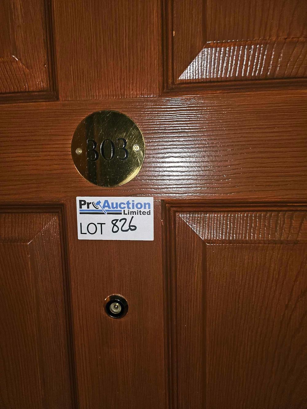 Lot 826: A Multi-Panel Wooden Entrance Door with Room Number Plaque and Auction Label
