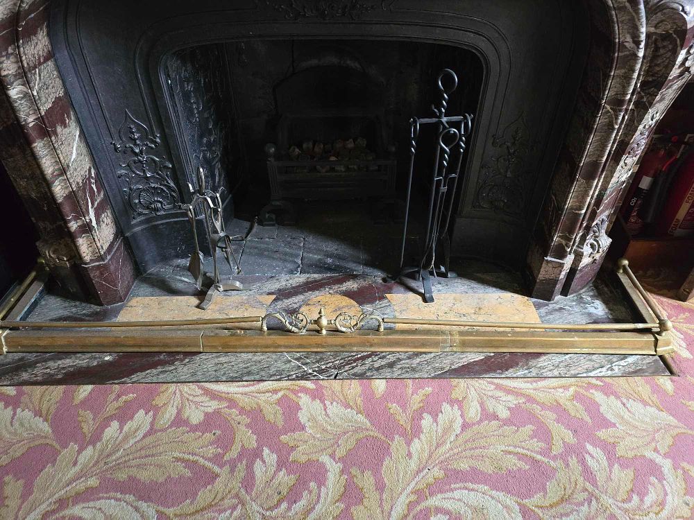 Lot 2027: A Louis XV Style Marble Fireplace Surround with Cast Iron Firebox, Brass Fender, and Fireplace Tools