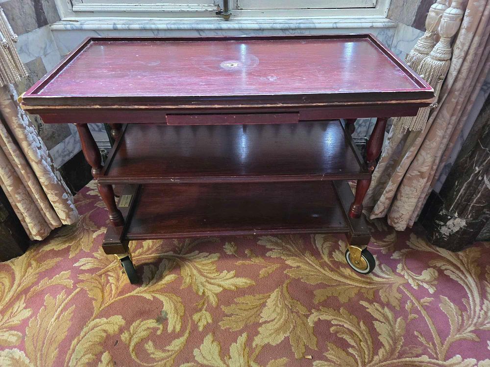 Lot 2028: A Dark-Stained Hardwood Three-Tiered Serving Trolley from Luton Hoo Hotel, Golf & Spa