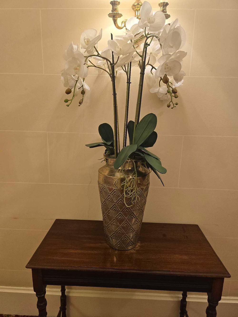 Lot 2072: A Large Faux Phalaenopsis Orchid Arrangement in a Textured Metallic Vase