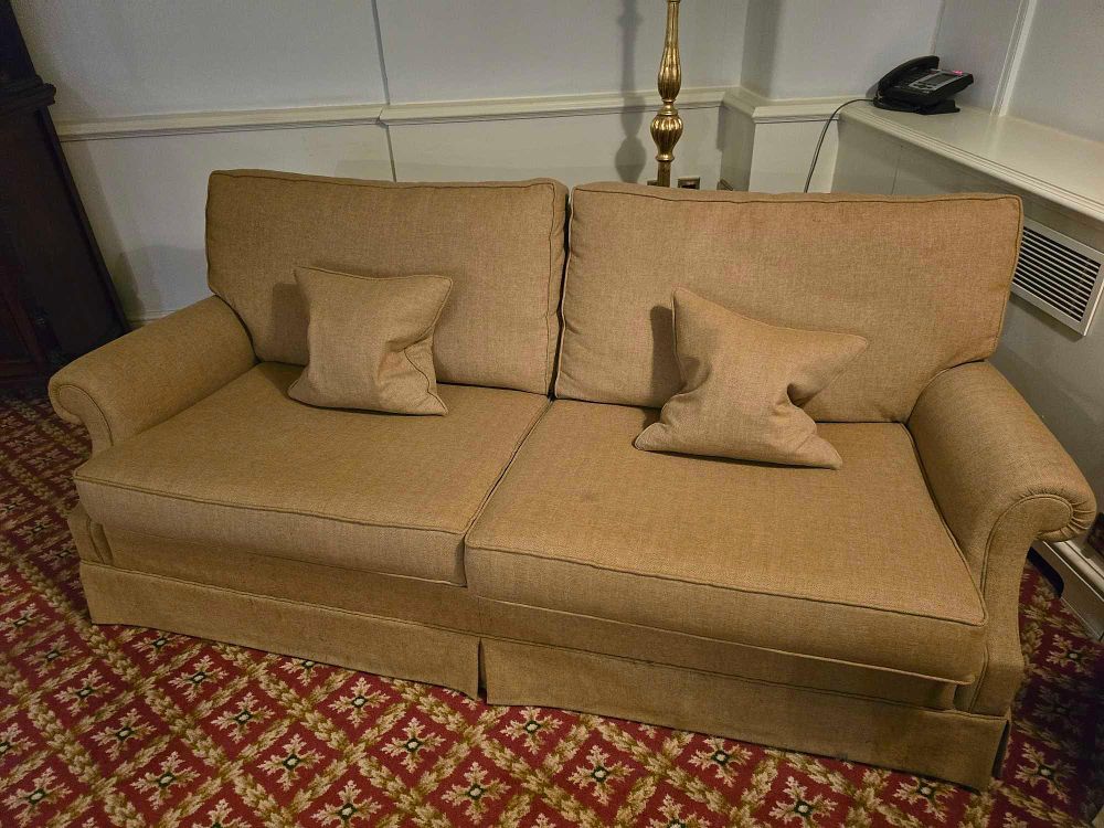 Lot 2141: A Transitional Style Rolled-Arm Skirted Loveseat