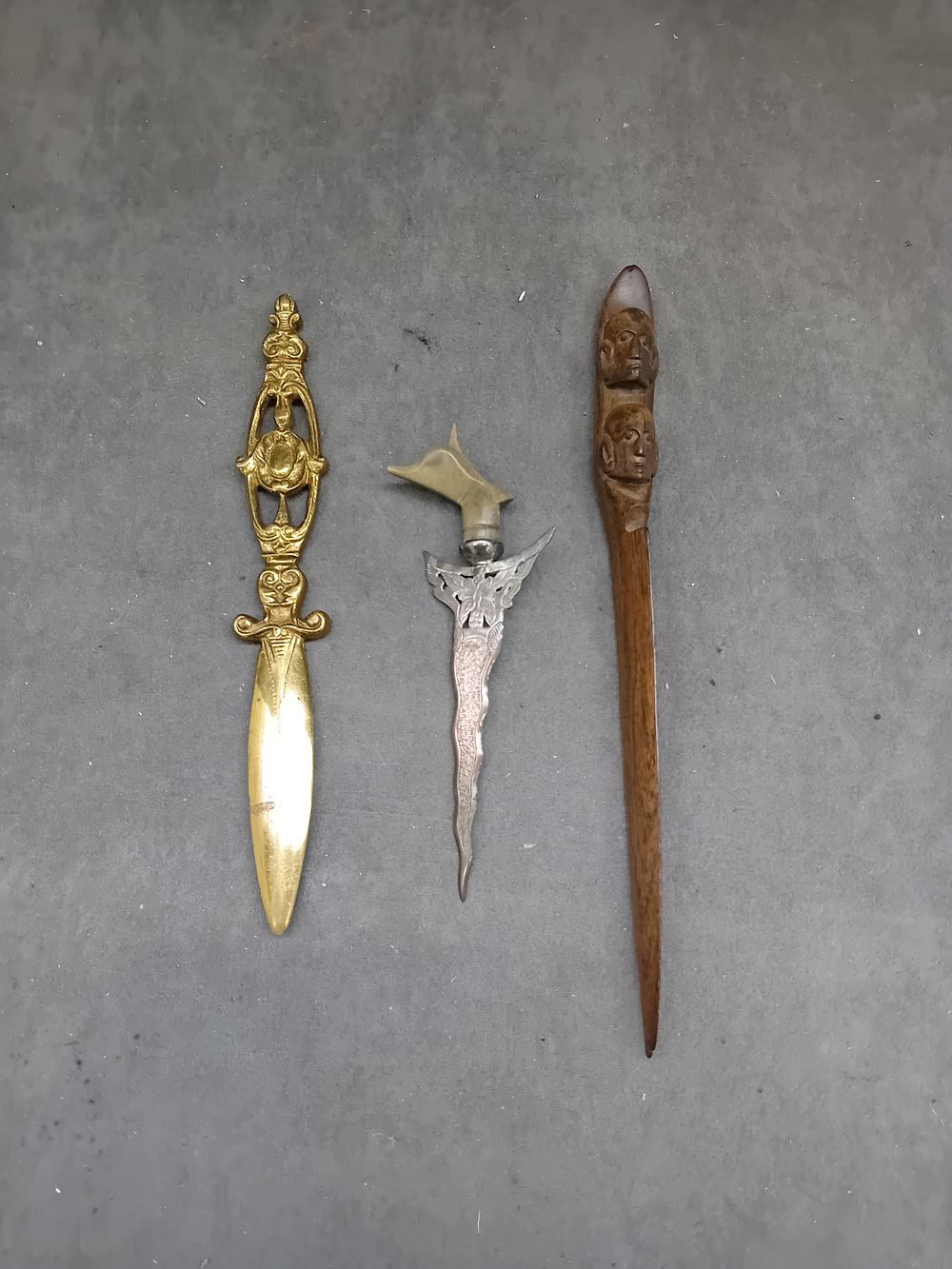 Lot 396: Three Southeast Asian Letter Openers, comprising a Malaysian Silver Kris Letter Opener, a Brass 'Bali' Letter Opener, and a Carved Wooden Letter Opener