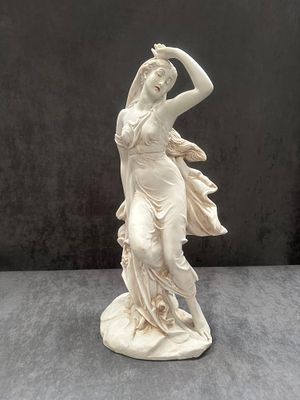 A Neoclassical Style Composite Figurine of a Female Figure. A composite figurine depicting a 