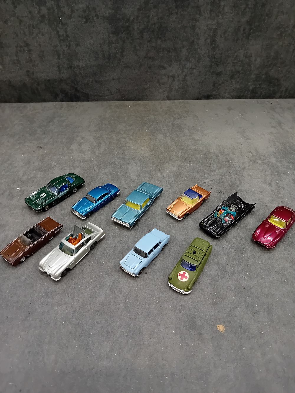 Lot 365: A Collection of Eleven Vintage Husky Die-Cast Toy Cars, including an Oldsmobile Starfire, James Bond's Aston Martin, and Batmobile