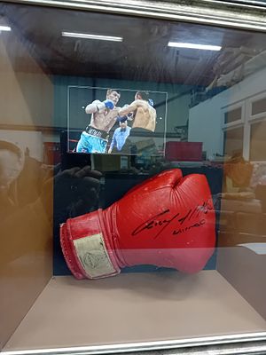 A Ricky Hatton Autographed VENOM Boxing Glove in Framed Display with Photograph. A modern 