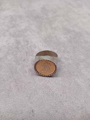 A Vintage Silver-Toned Ring Set with a Queen Victoria Veiled Head Coin. A single vintage coin 