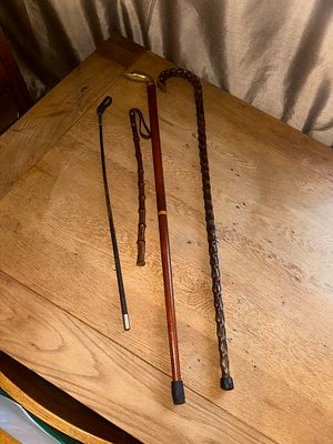 A Collection of Four Vintage Walking Sticks, Canes, and Riding Crop. A collection of four 