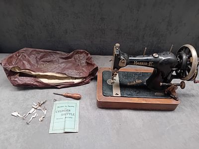 A Harris-E. British Made Hand-Crank Sewing Machine with Accessories. A collection of 12 items 