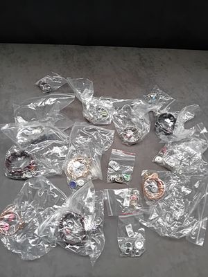 A Collection of 16 Individually Packaged Contemporary Costume Jewelry Items and Snap Charms. The 