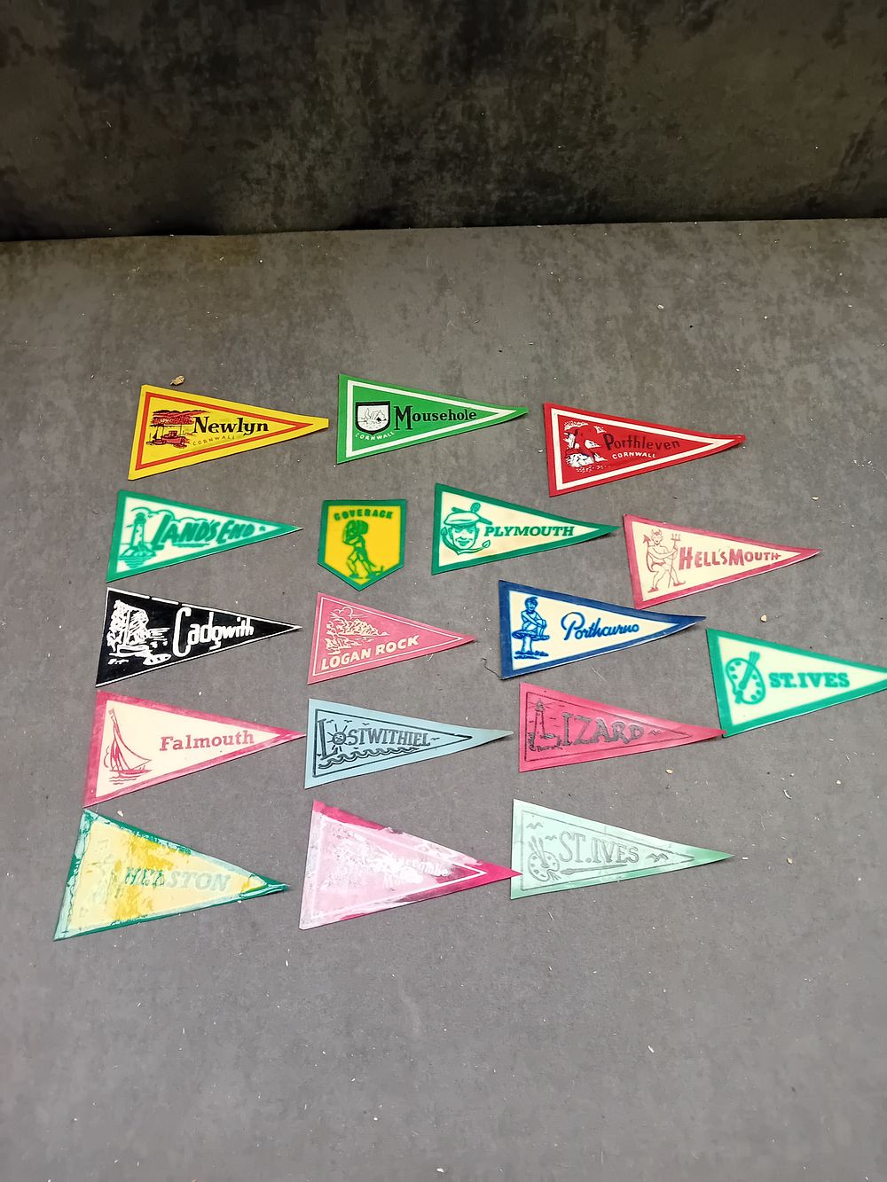 Lot 551: A Collection of 17 Vintage Plastic Souvenir Pennants, UK Tourist Destinations, Mid-20th Century