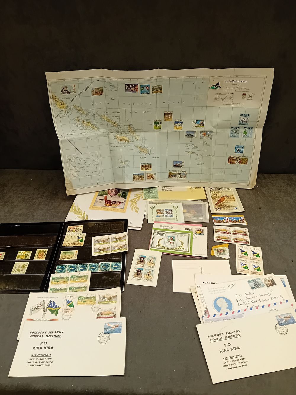 Lot 557: A Collection of Solomon Islands Philatelic Material, Early 1980s, Including First Day Covers and a Stamped Map