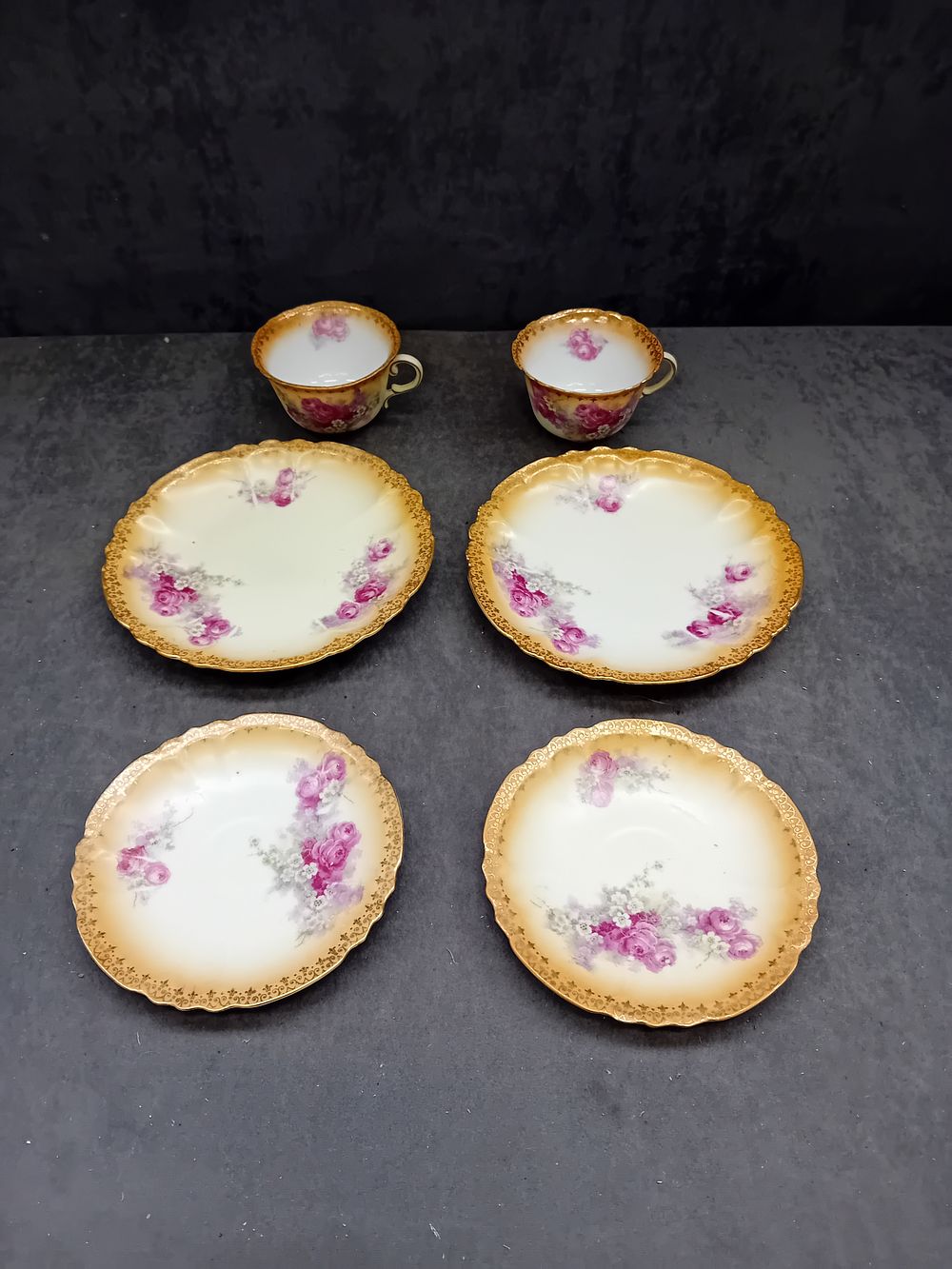 Lot 591: Two Austrian Victoria Carlsbad (Schmidt & Co) Porcelain Teacups and Four Matching Saucers